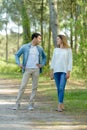 young couple chatting while walking along country path