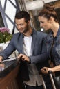 Young couple checking in at hotel reception Royalty Free Stock Photo