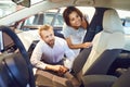 Young couple choose a new car in showroom. Royalty Free Stock Photo