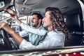 Young couple choosing car in car dealership