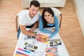 Young couple choosing color from swatch Royalty Free Stock Photo