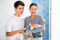 Young couple choosing color from swatch palette for new home interior Royalty Free Stock Photo