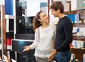 Young couple choosing kitchen stove Royalty Free Stock Photo
