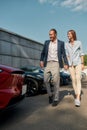 Young couple choosing new car in showroom Royalty Free Stock Photo