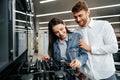 Young couple choosing new gas stove in home appliances store Royalty Free Stock Photo