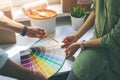 couple choosing paint color from swatch for new home interior Royalty Free Stock Photo