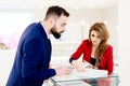 Young couple choosing wedding ring in jewelry store. Royalty Free Stock Photo