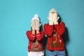 Young couple in Christmas sweaters and knitted hats