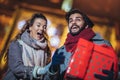 Young couple in the city centre with holiday`s brights in background. Royalty Free Stock Photo