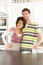 Young Couple Cleaning Modern Kitchen