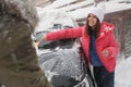 Young couple cleaning snow from car on winter day Royalty Free Stock Photo