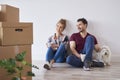 Young couple with coffee cups relaxing in their new home Royalty Free Stock Photo