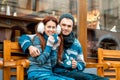 Young couple with coffee in winter outside