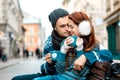 Young couple with coffee in winter outside