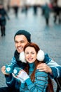 Young couple with coffee in winter outside