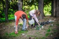 Young couple collect garbage thrown in nature park