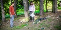 Young couple collect garbage thrown in nature park