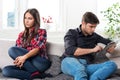 Young couple in conflict, a guy with a tablet Royalty Free Stock Photo