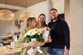 Young couple congratulates female blonde with her birthday Royalty Free Stock Photo