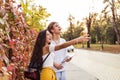 Young couple consulting a city guide and the digital tablet gps in the street searching locations Royalty Free Stock Photo