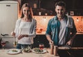 Young Couple Cooking Dinner and Drink Red Wine. Royalty Free Stock Photo