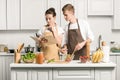 young couple cooking salad and reading recipe in cookbook Royalty Free Stock Photo