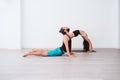 young couple Couple practicing acro yoga in white studio or gym. Healthy lifestyle