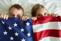 Young couple covering by American flag Royalty Free Stock Photo