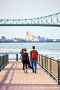 Young couple crossing the bridge over saint lawrence river in Montreal, Quebec, Canada Royalty Free Stock Photo