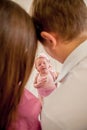 Young couple with cute little baby. Smiling mother and father holding their newborn baby daughter at home. couple kissing. hugging Royalty Free Stock Photo