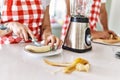 Young couple cutting banana at kitchen Royalty Free Stock Photo