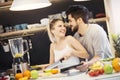 Young couple cutting fruit in the kitchen Royalty Free Stock Photo