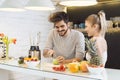 Young couple cutting fruit in the kitchen Royalty Free Stock Photo