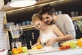 Young couple cutting fruit in the kitchen Royalty Free Stock Photo