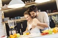 Young couple cutting fruit in the kitchen Royalty Free Stock Photo