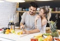 Young couple cutting fruit in the kitchen Royalty Free Stock Photo