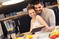 Young couple cutting fruit in the kitchen Royalty Free Stock Photo