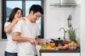 Couple cutting vegetables for preparing healthy food in the kitchen at home. woman making massage to man Royalty Free Stock Photo