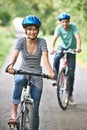 Young Couple Cycling Along Country Road