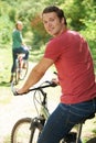 Young Couple Cycling Along Country Track Royalty Free Stock Photo