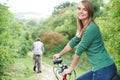 Young Couple Cycling Along Country Track Royalty Free Stock Photo