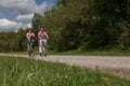 Young couple cycling with modern small e-bikes Royalty Free Stock Photo