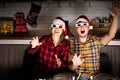 Young couple in 3D glasses watching movies at home at christmas Royalty Free Stock Photo