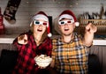 Young couple in 3D glasses watching movies at home at christmas Royalty Free Stock Photo