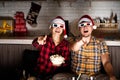 Young couple in 3D glasses watching movies at home at christmas Royalty Free Stock Photo