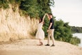 Young couple dancing at beach on sunny day Happy Romantic young Couple Enjoying Beautiful Sunset Walk on the Beach Royalty Free Stock Photo