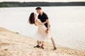 Young couple dancing at beach on sunny day Happy Romantic young Couple Enjoying Beautiful Sunset Walk on the Beach Royalty Free Stock Photo