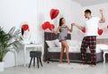 Young couple dancing in bedroom decorated with air balloons. Celebration of Saint Valentin