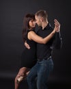Young couple dancing on a dark background Royalty Free Stock Photo
