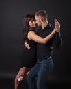 Young couple dancing on a dark background Royalty Free Stock Photo